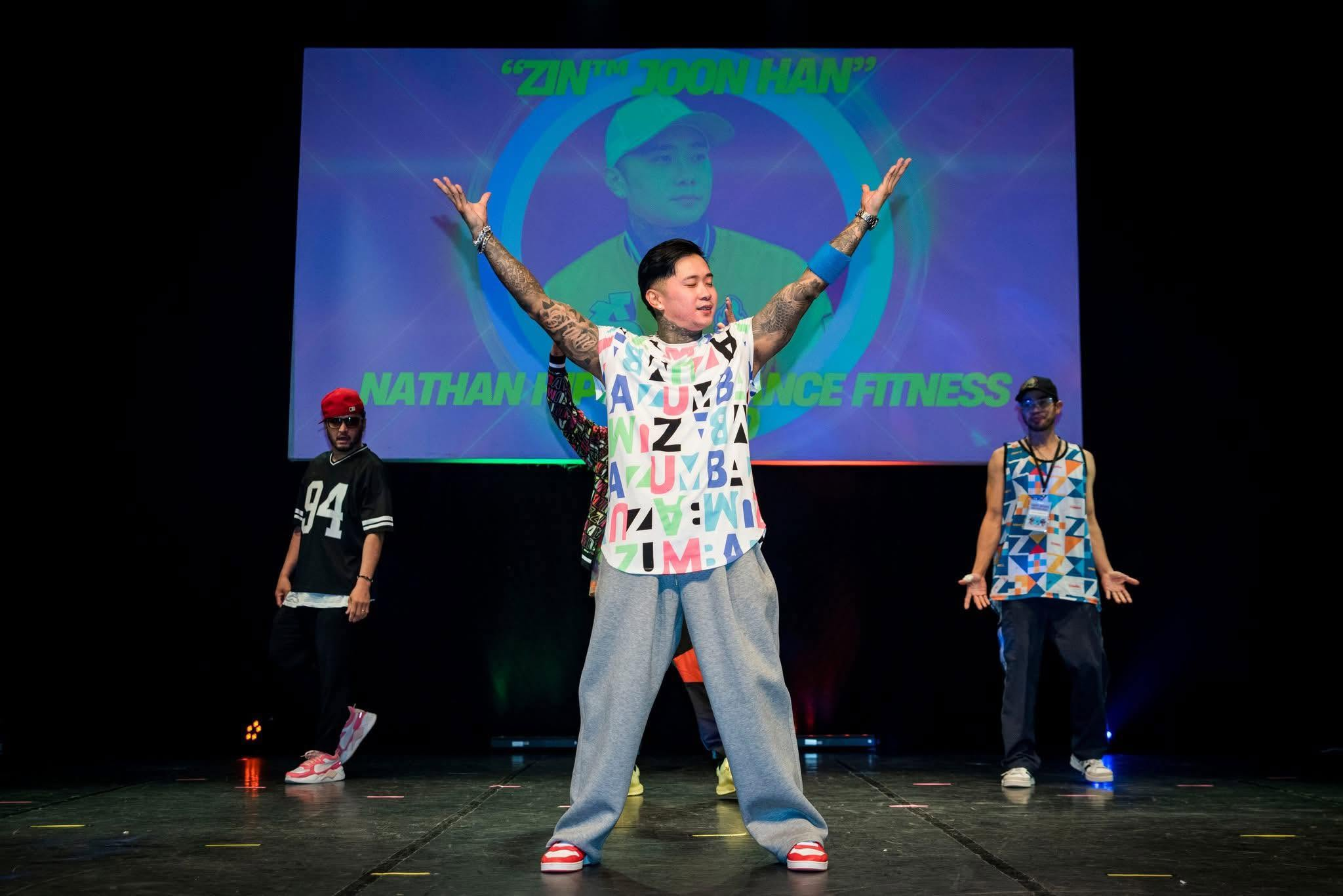 Zin Nathan leading a dance performance on stage